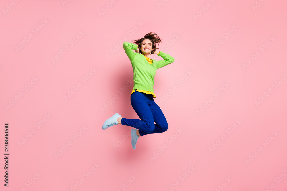 Full size photo of young excited girl happy smile have fun enjoy carefree jump up isolated over pink color background Full size photo of young excited girl happy smile have fun enjoy carefree jump up isolated over pink color background