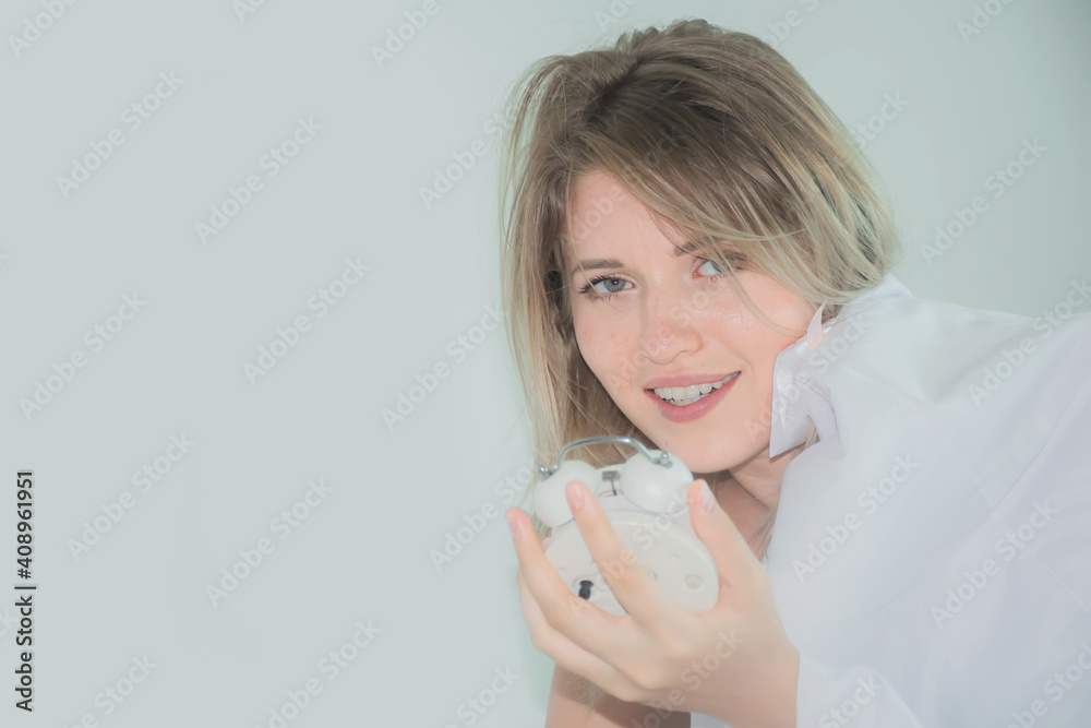 Hand holding the alarm clock waking up at morning Hand holding the alarm clock waking up at morning
