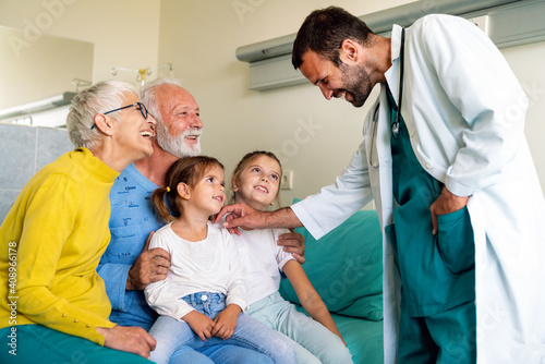 Family visiting mature male patient in hospital. Healthcare  pensioner  family support concept