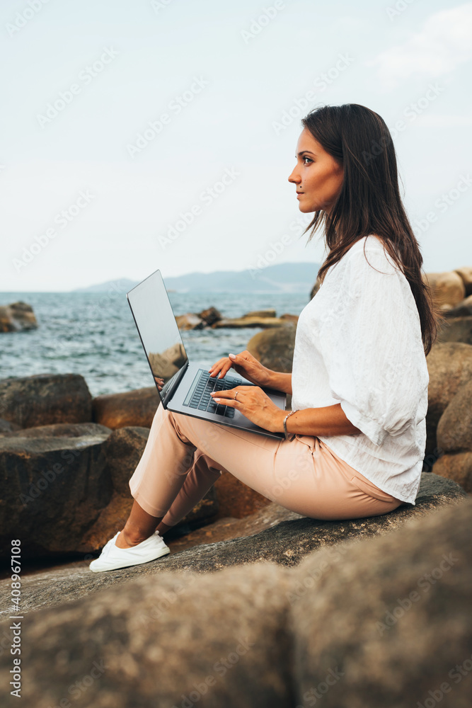 Freelance concept. A freelancer girl with a laptop on her lap works out of the office