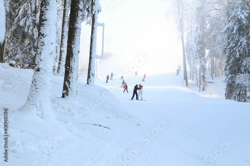 View with snow covered mountains, ski slope. Skiing, snowboard in Latvia. Winter wonderland. Frozen.