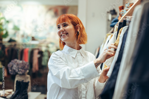 Woman enjoying shopping in fashion store photo