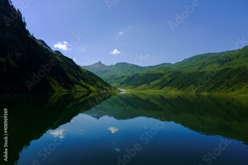 clear deep blue mountain lake with gorgeous reflection from the landscape