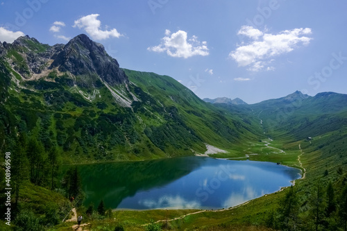 deep blue mountain lake in a green wonderful landscape in the summer