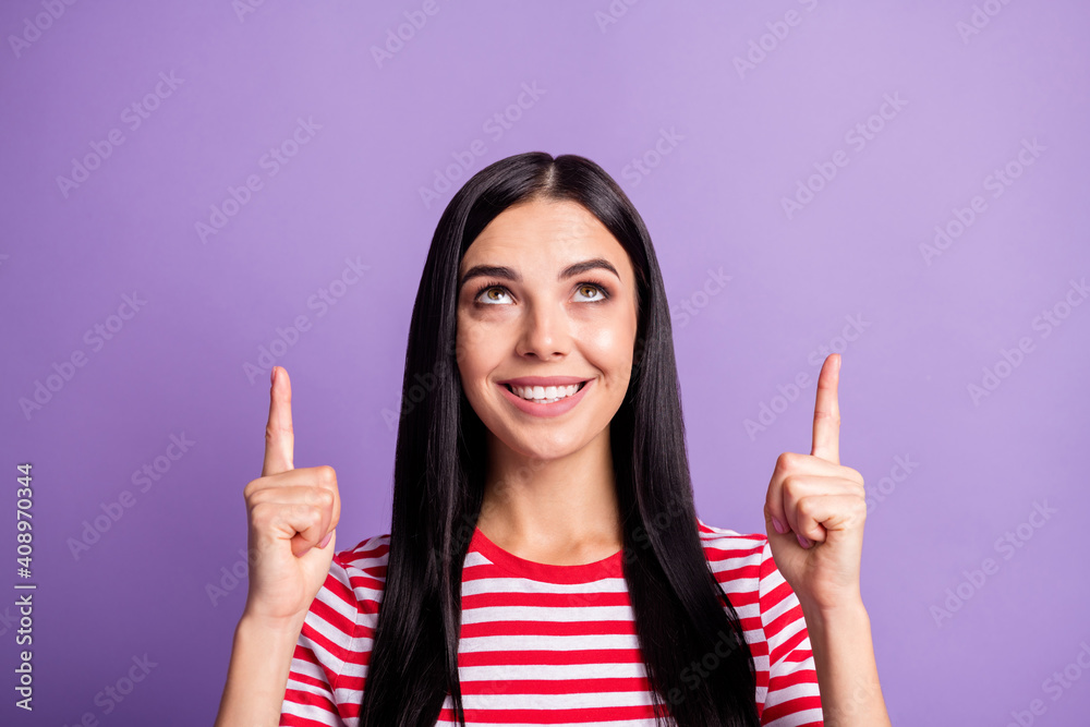Portrait of cheerful brunette lady point look empty space wear red striped t-shirt subscribe follow isolated on violet color background Portrait of cheerful brunette lady point look empty space wear red striped t-shirt subscribe follow isolated on violet color background