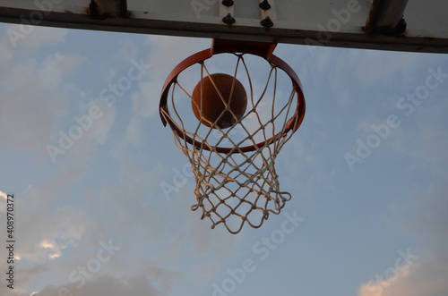 Bottom view of the basketball hoop. The moment the ball passes through the hoop. Success, goal. © Alp Guvenc