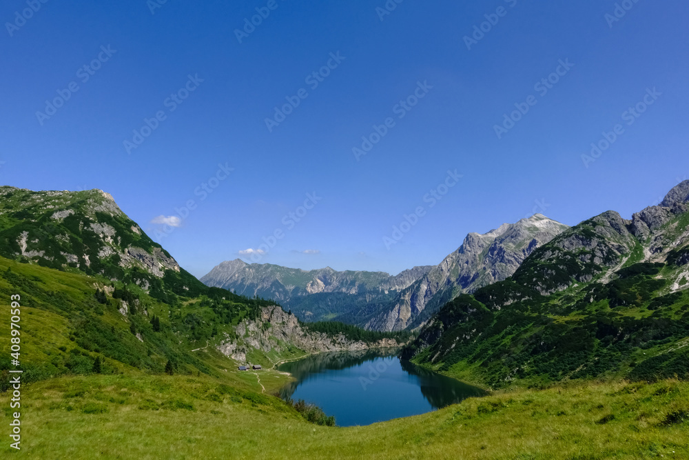 gorgeous deep blue lake in a mountain landscape with blue sky