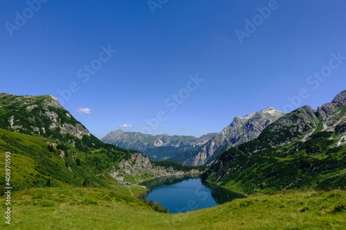 gorgeous deep blue lake in a mountain landscape with blue sky