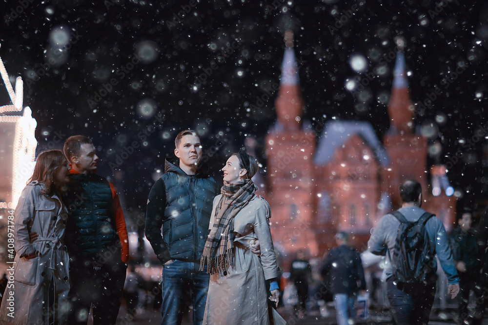 red square evening winter, a group of friends for a walk new year christmas moscow russia