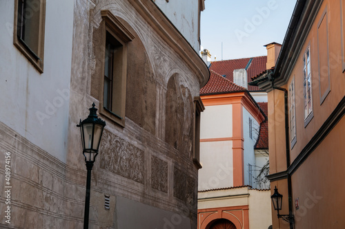 Beautiful renaissance house, facade is richly decorated with figural sgraffito, Martinic Palace at Hradcany Square nearby Prague Castle, sunny winter day, Prague, Czech Republic photo