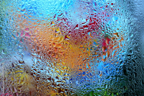 the illusion of color in drops of condensation on a window pane
