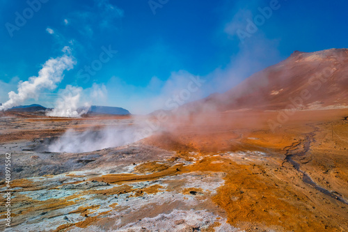 Colorful geothermal active zone Hverir near Myvatn lake in Iceland, resembling Martian red planet landscape, at summer and blue sky.
