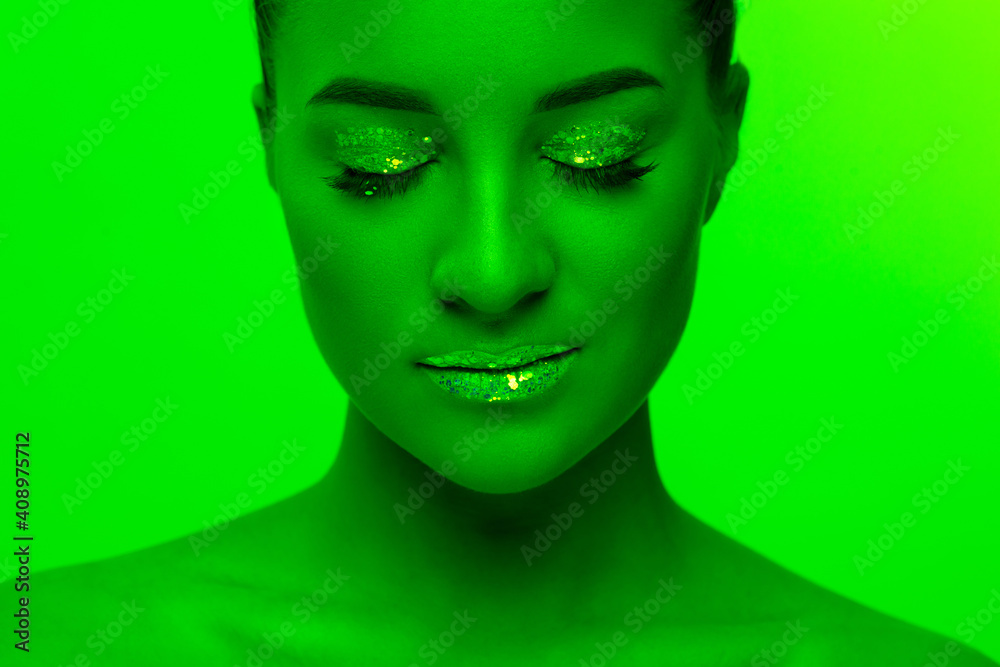 Stars. Handsome woman's portrait isolated on green studio background in neon light, monochrome. Beautiful female model. Concept of human emotions, facial expression, sales, ad, fashion and beauty.