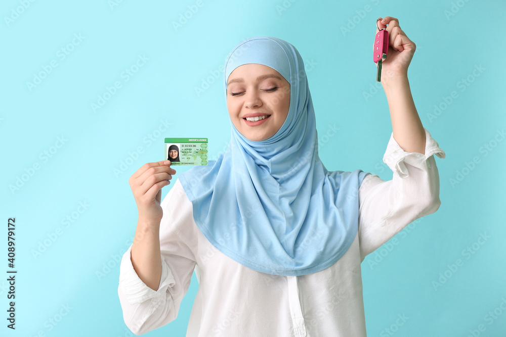 Happy Muslim woman with driving license and car key on color background Happy Muslim woman with driving license and car key on color background