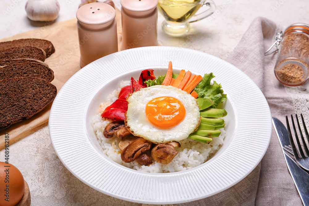 Plate with tasty egg, vegetables and rice on table Plate with tasty egg, vegetables and rice on table