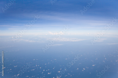 Aerial view of Blue sky and Cloud Top view from airplane window,Nature background. Sky and clouds. © Tatiana Nurieva