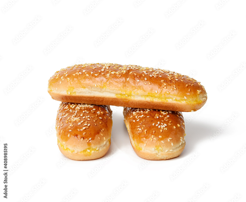 baked oval hot dog bun, baked goods sprinkled with sesame seeds and isolated on white background