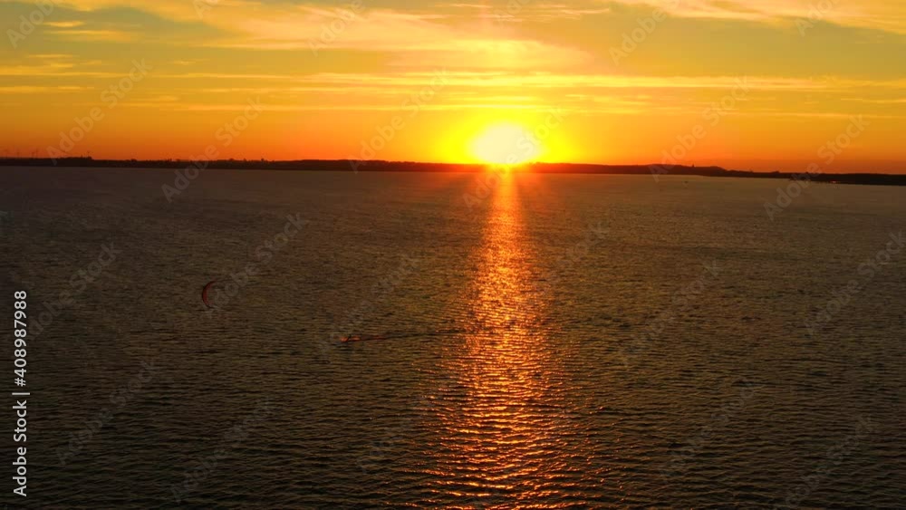 Aerial view young people kite surfing in the Baltic Sea, Gdansk. Poland. Drone view of the ocean and people engaged in extreme sports, kitesurfing. Summer Fun Action Sports. Sunset Aerial view young people kite surfing in the Baltic Sea, Gdansk. Poland. Drone view of the ocean and people engaged in extreme sports, kitesurfing. Summer Fun Action Sports. Sunset