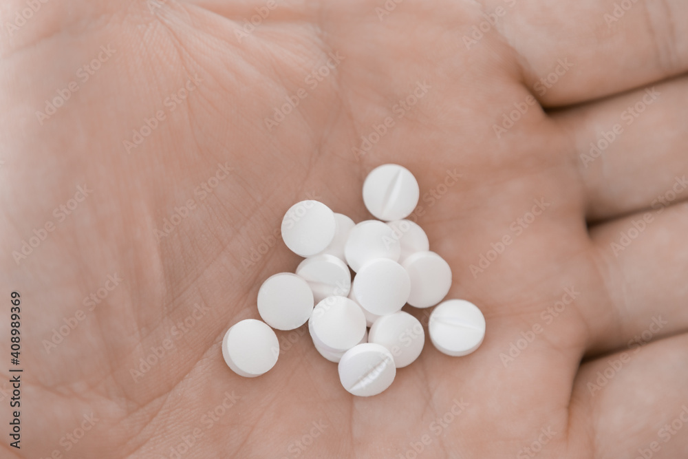close up of drug pills in the palm of hand close up of drug pills in the palm of hand