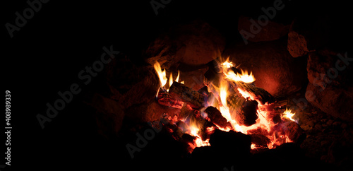 Campfire and black space for text © Guy Sagi