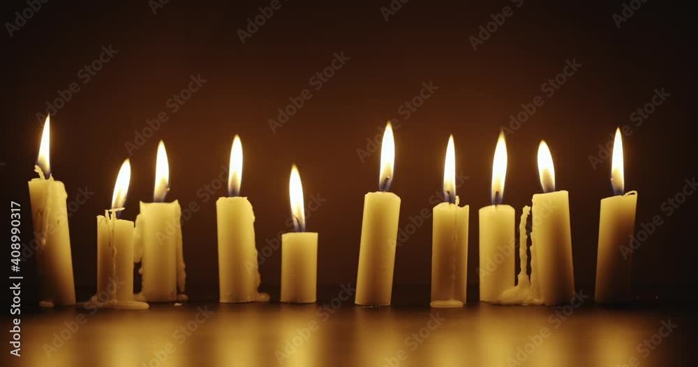 Candles glowing against dark background