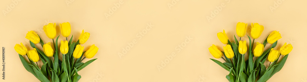 Bouquets of yellow tulips on beige background. Wide banner with copy space. Bouquets of yellow tulips on beige background. Wide banner with copy space.