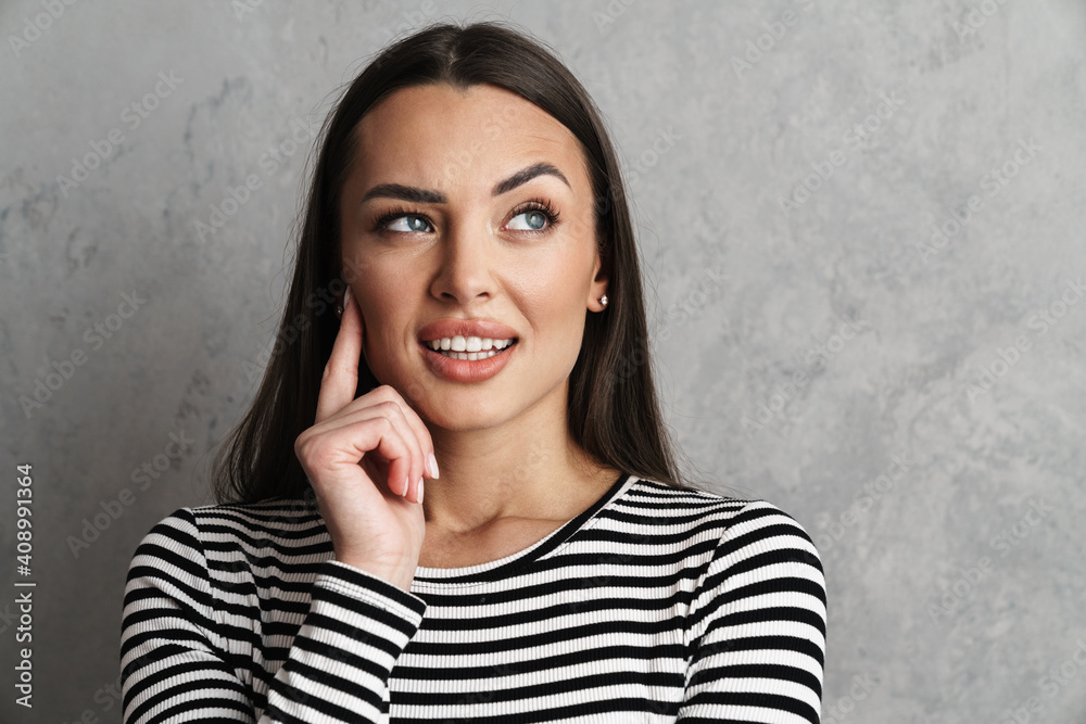 Close up of an attractive young pensive brunette woman