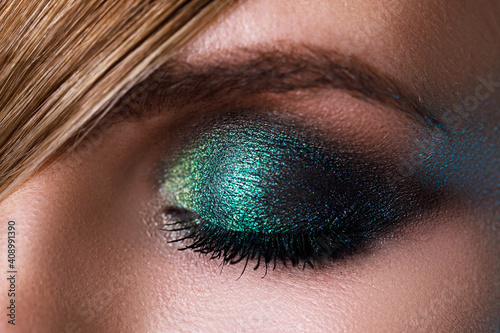 Female eye with a green eyeshadow photo