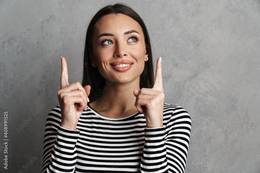 Smiling beautiful young woman presenting copy space