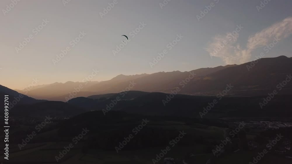 Paraglider on the background of alpine meadows. Aerial footage. High quality 4k footage