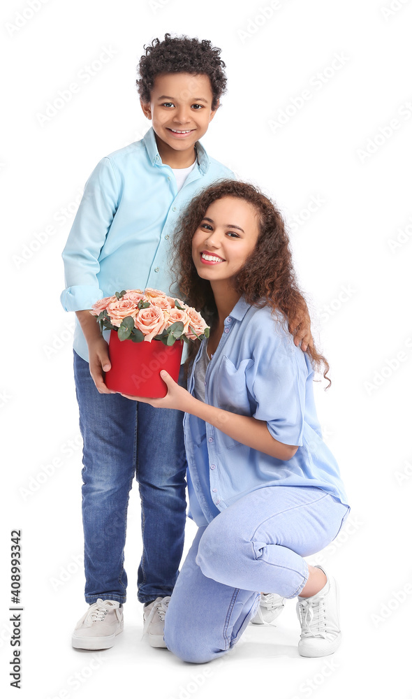 African-American boy and his mother with flowers on white background African-American boy and his mother with flowers on white background