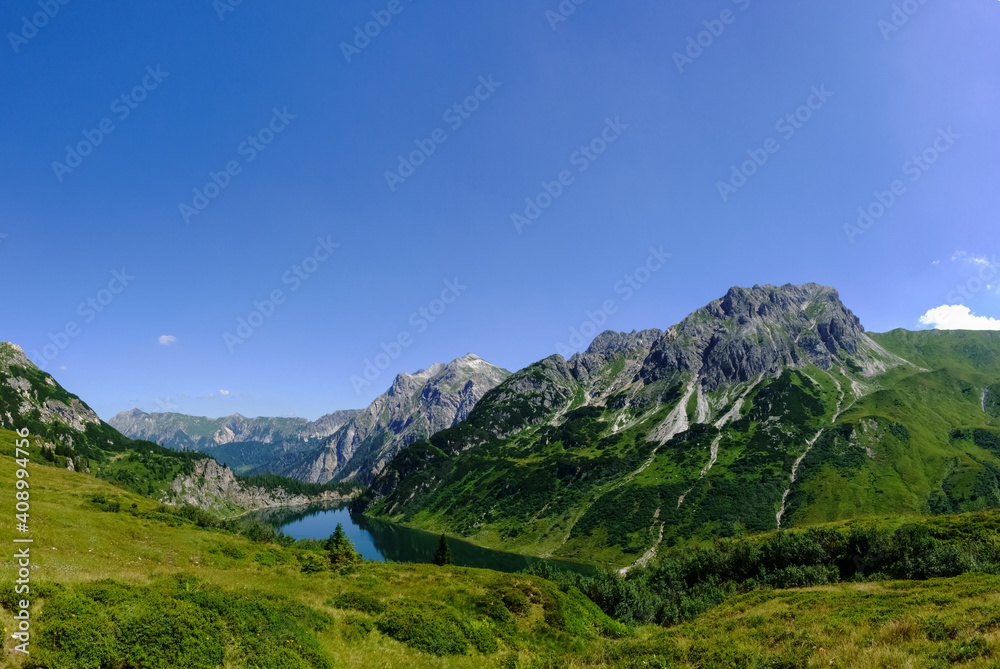gorgeous deep blue lake in a mountain landscape with blue sky  panorama