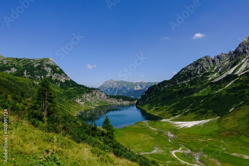 gorgeous green mountain landscape with a deep blue lake