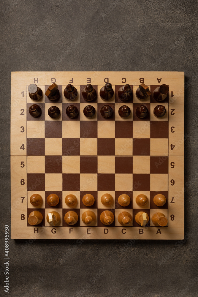 Chess pieces on a chessboard on a dark background Chess pieces on a chessboard on a dark background