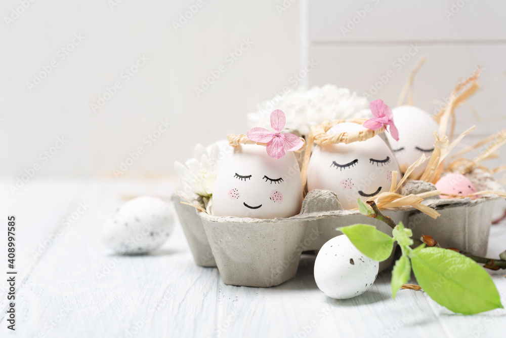 Easter holiday concept with cute handmade white eggs, tree branches, quail feathers and spring flowers on white wooden background. Easter holiday concept with cute handmade white eggs, tree branches, quail feathers and spring flowers on white wooden background.