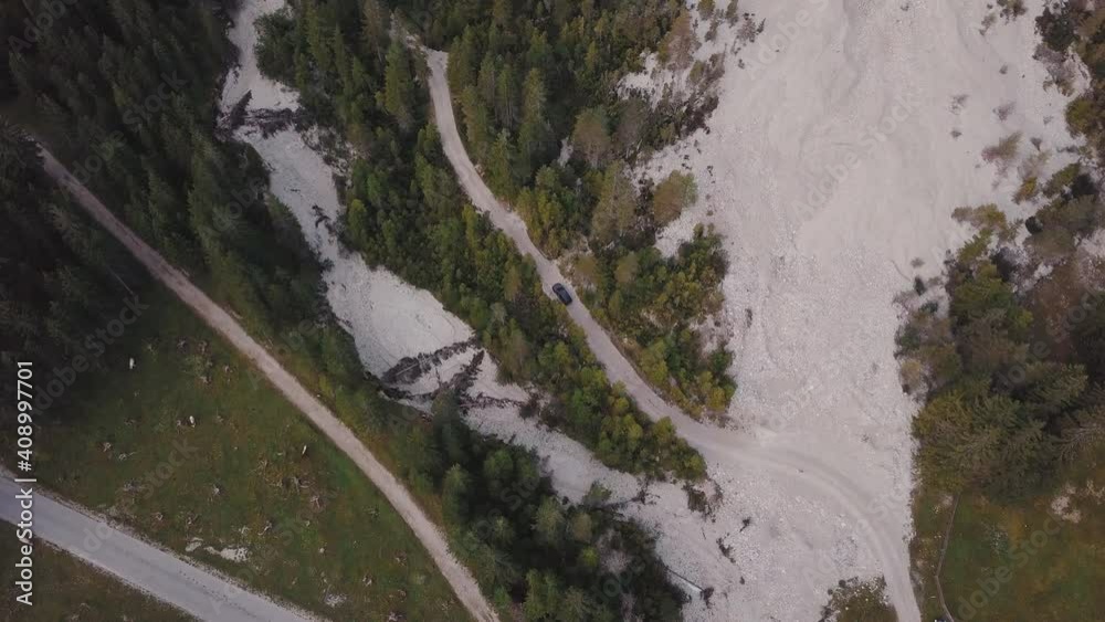 Black car moves along a mountain serpentine and stops. Dolomites. top view. aerial footage High quality 4k footage Black car moves along a mountain serpentine and stops. Dolomites. top view. aerial footage High quality 4k footage