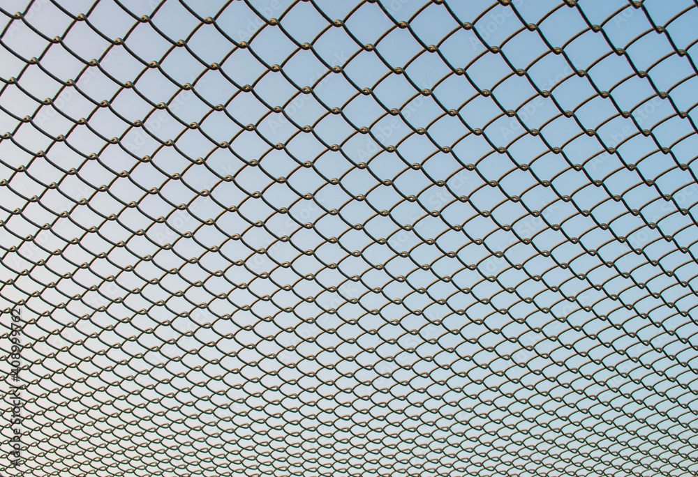 Fototapeta premium Iron net on the sky background 