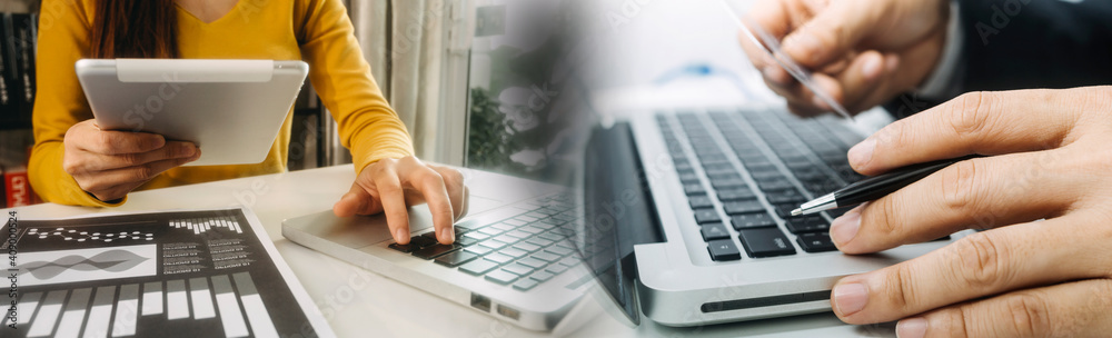 Business people use tablets and hold credit cards as an online shopping concept With a calculator and a book placed on the table Business people use tablets and hold credit cards as an online shopping concept With a calculator and a book placed on the table