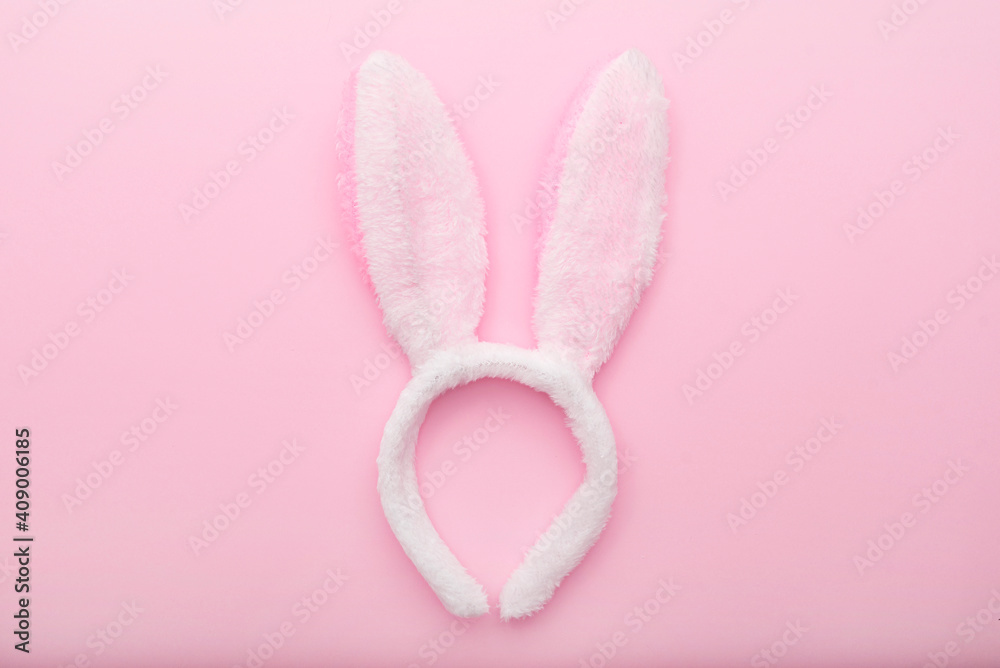 White rabbit ears on pink background, Easter minimal flat lay, top view, space for text