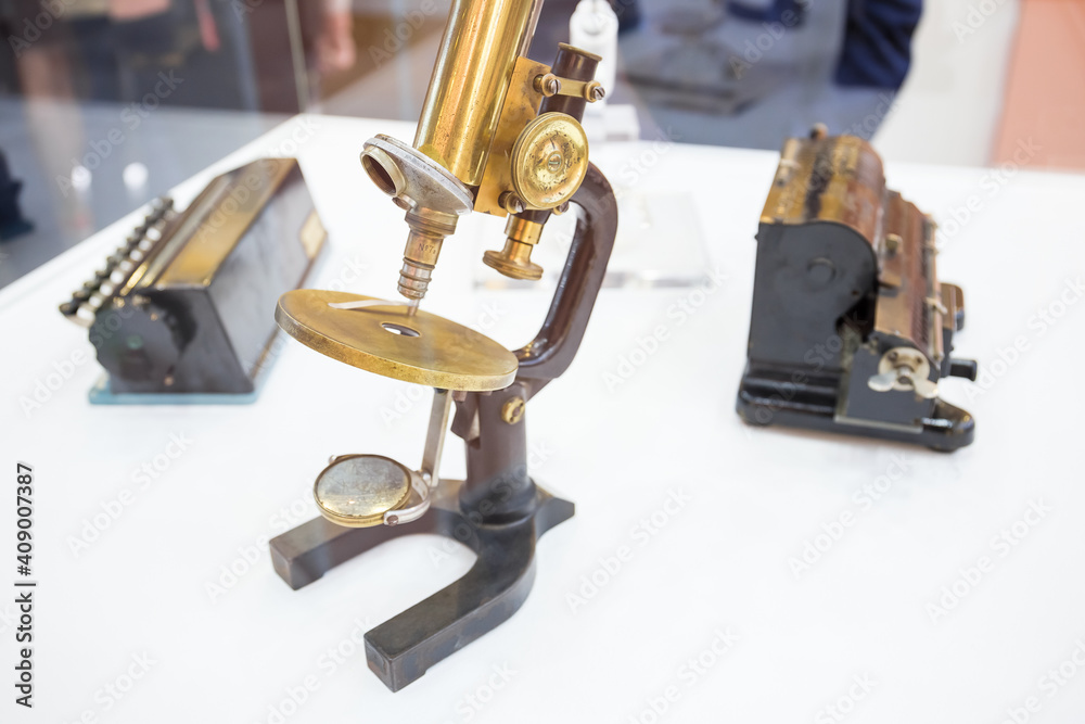 Old vintage microscope on a white background