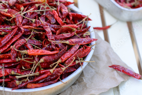 dried red peppers on a tray outdoor, closeup view