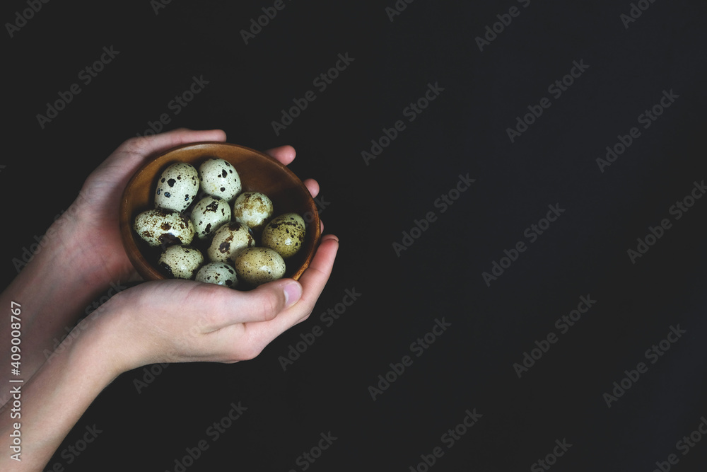 The man is holding quail eggs. Natural organic farm product. Preparing for the Easter holiday. Fresh food delivery, cardboard packaging. Raw materials for cooking The man is holding quail eggs. Natural organic farm product. Preparing for the Easter holiday. Fresh food delivery, cardboard packaging. Raw materials for cooking