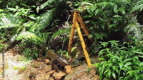 Small Monjolo, a rustic hydraulic machine for grinding grains, a primitive water powered hammer. photo