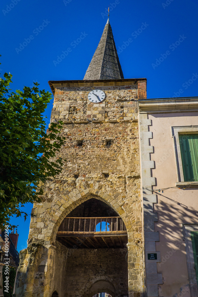 Low angle shot of the clock tower in Herisson, a small medieval village in Auvergne, France