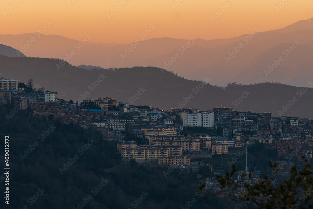 an old town on hills in sunset