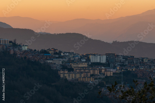 an old town on hills in sunset