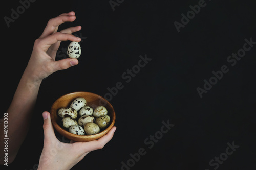 The man is holding quail eggs. Natural organic farm product. Preparing for the Easter holiday. Fresh food delivery, cardboard packaging. Raw materials for cooking 