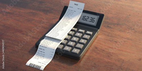 Fotografie Sales receipt and calculator on wooden background
