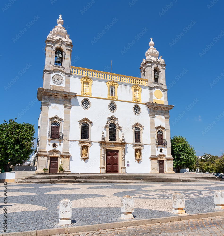 Catholic church named Igreja do Carmo in Faro, Portugal. Taken with a clear blue sky in the background.