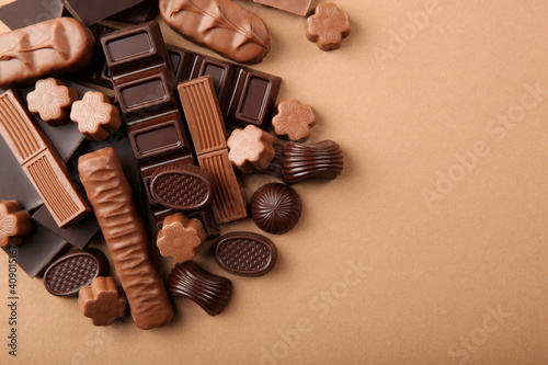 Chocolate products of different types on a colored background close-up with a place for text 